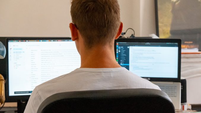 a man sitting in front of a computer