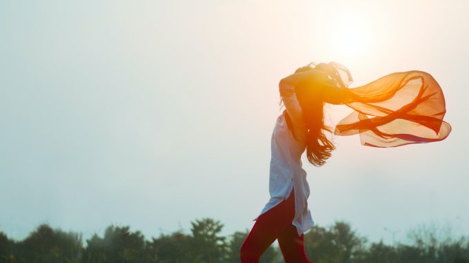 woman spreading hair at during sunset